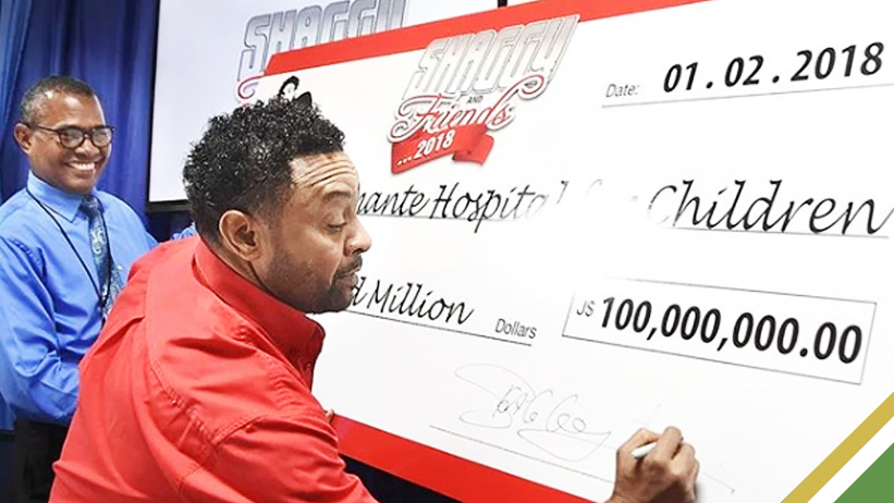 Shaggy handing over Cheque to Bustamante Hospital for Children