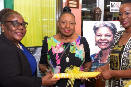 Minister of Culture, Gender, Entertainment and Sport, Hon. Olivia Grange (centre) and National Librarian at the National Library of Jamaica, Beverley Lashley (left), accept the representative deed of the Leonie Forbes Collection from Actress, Karen Harriot.