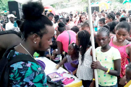 Popcaan assisting with supplies at his Back To School Treat