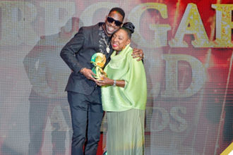 Minister Hon. Olivia Grange embraces dancehall icon Bounty Killer after presenting him with a trophy at the 2024 Reggae Gold Awards and Jamaica Music Museum Hall of Fame Inductions ceremony. (📷 : Donald De La Haye)