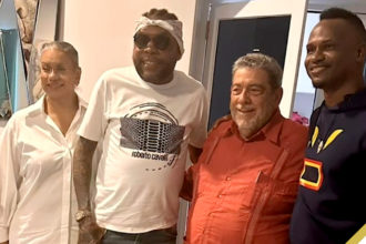 (L-R) Eloise Gonsalves wife of Prime Minister Ralph Gonsalves (orange shirt), Vybz Kartel and Marlon Samuels