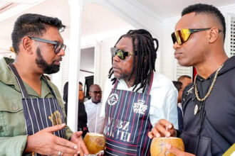 (L-R) President of Guyana His Excellency Dr Mohamed Irfaan Ali converses with Vybz Kartel and Sports Star Marlon Samuels