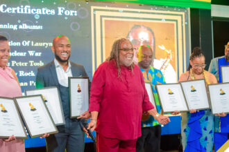 Saxophonist Dean Fraser collecting his 9 Grammy-winning certificates at the 2024 staging of the Back 2 Da Future Music Limited's Grammy Certificate Ceremony held in August.